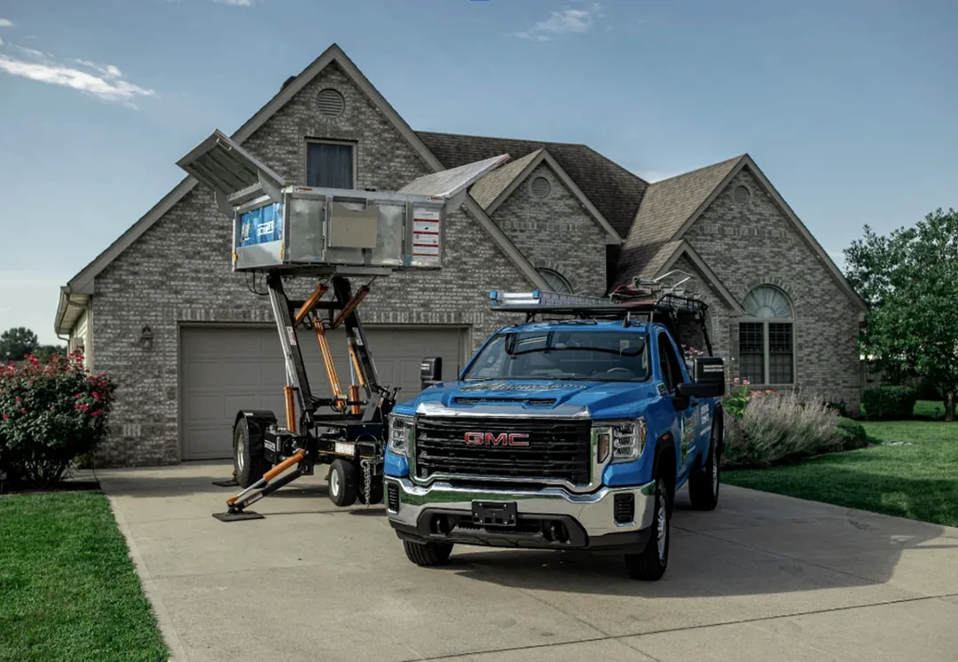 Blue service truck outside a residential property