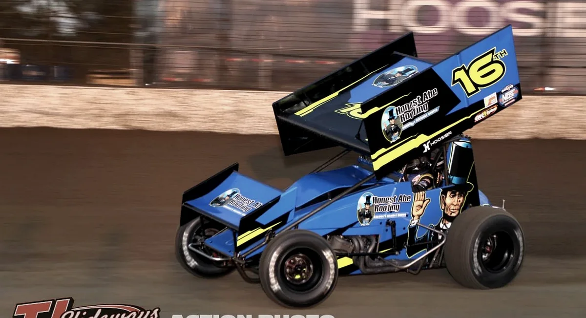 Sprint car racing at speed on a dirt track